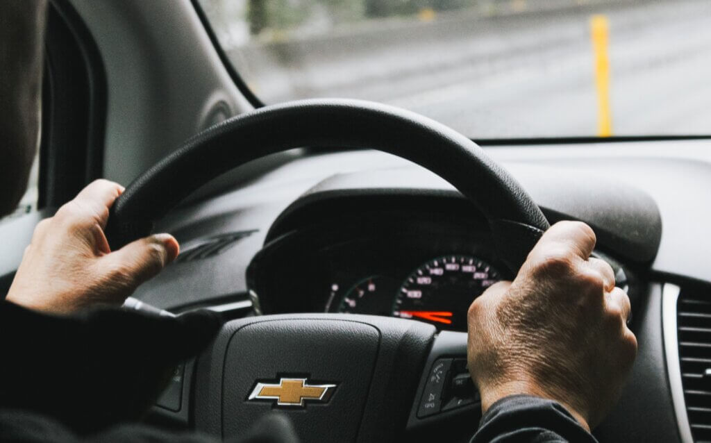 Man holding steering wheel.