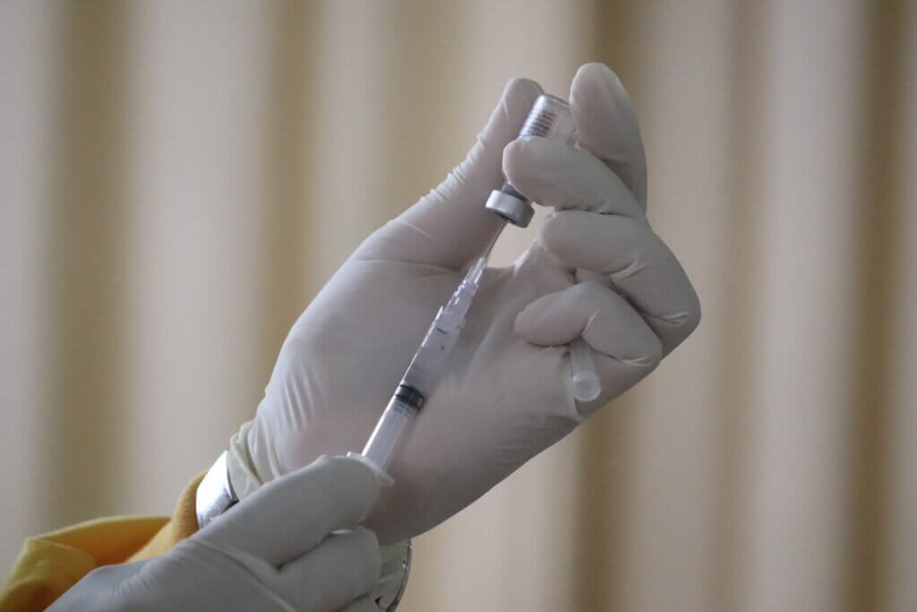 Person preparing to give vaccine